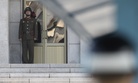 A North Korean soldier, left, looks at the South side as a South Korean soldier, right, stands guard at the truce village of Panmunjom in the Demilitarized Zone in Paju, South Korea, Sept. 28, 2017.
