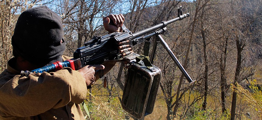 A Pakistani Taliban militant firing a machine gun in Waziristan