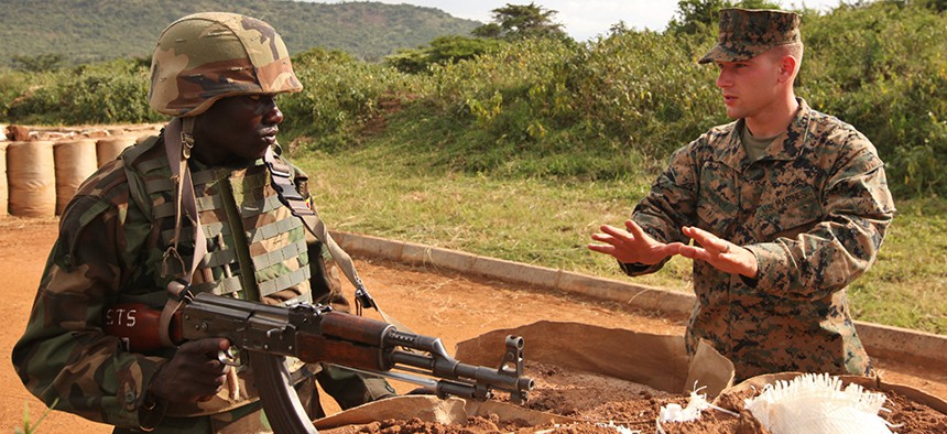 A Marine Corps Sgt. training a soldier in the Uganda People's Defense Force