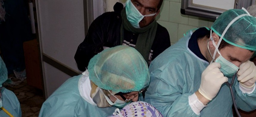 Doctors treat a victim of a chemical weapons attack in Syria in March 2013