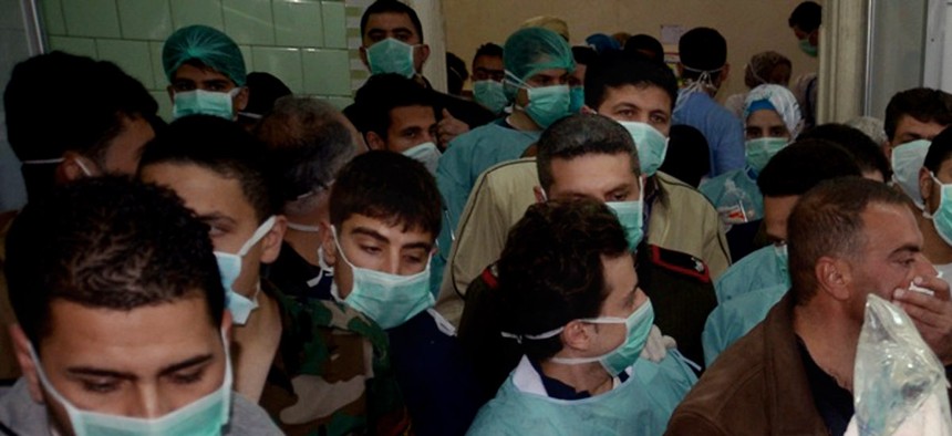 Doctors treat a victim of an a possible chemical attack at a village in Syria