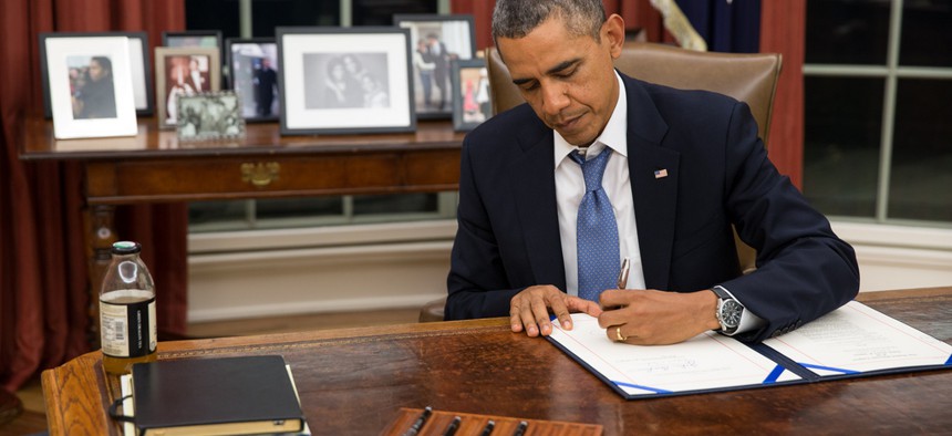 President Obama signs the Pay Our Military Act on Oct. 1.