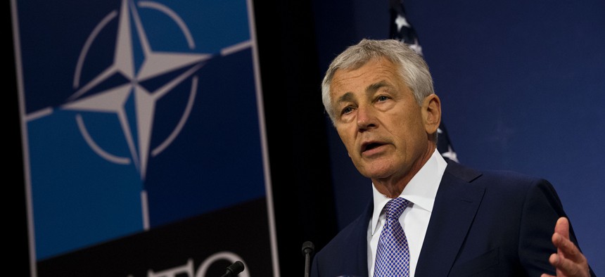 Defense Secretary Chuck Hagel briefs the press at a NATO meeting in Brussels in June. 