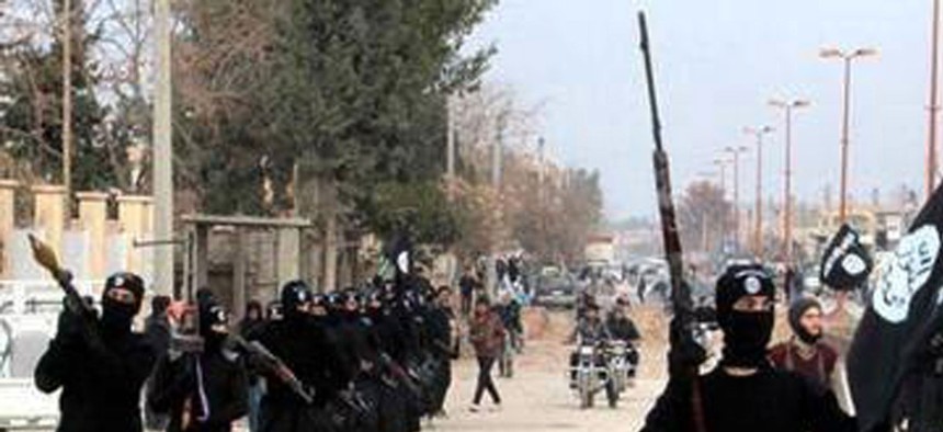 Fighters with the al-Qaeda linked Islamic State of Iraq and the Levant march through Raqqa, Syria