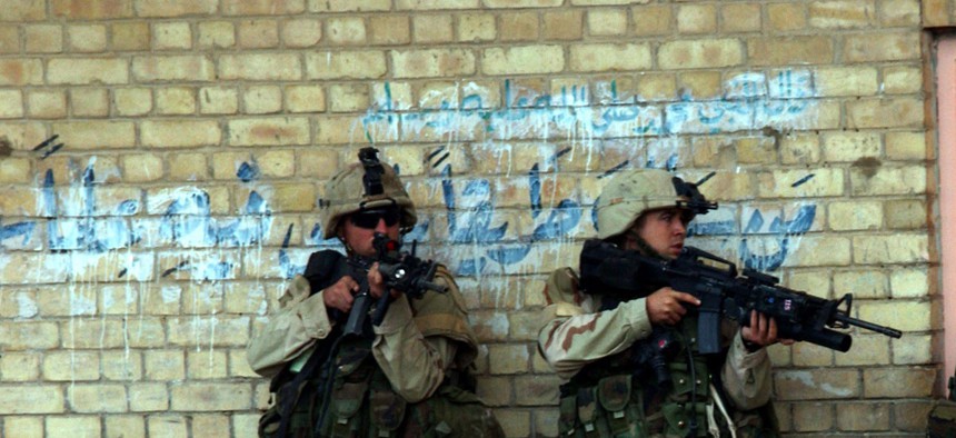 Soldiers from the 2nd Battalion, 5th Cavalry Regiment, 2nd Brigade Combat Team enter a building in Fallujah, Iraq, during Operation Al Fajr on Nov. 9, 2004.