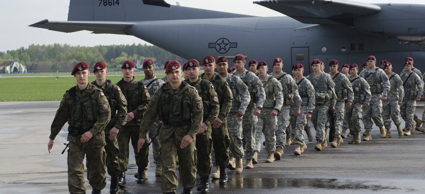 Paratroopers with the 173rd Infantry Brigade Combat Team march with members of the Polish Army's 6th Airborne Brigade at Swidwin Air Base, Poland, on April 23, 2014. 