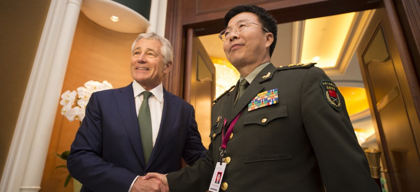 Defense Secretary Chuck Hagel meets with Lt. Gen. Wang Guanzhong, the deputy chief of the General Staff of China at the Shangri-La Dialogue in Singapore on Saturday. 