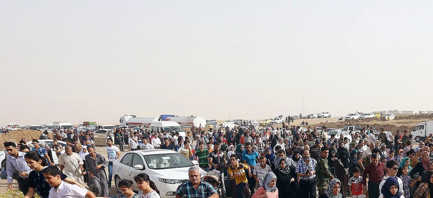 Refugees flee from Mosul to the self-ruled northern Kurdish region of Irbil, Iraq, on June 12, 2014.