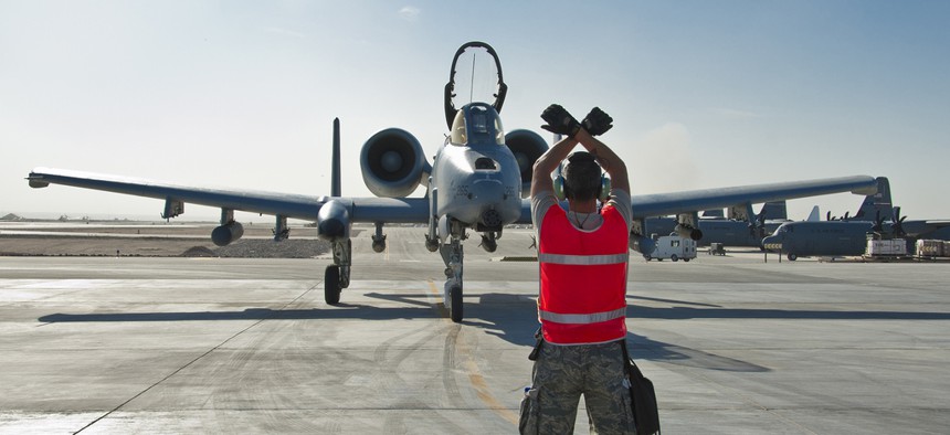 A U.S. Air Force sergeant directs an A-10 Thunderbolt II aircraft for an end of runway inspection, on November 10, 2011.