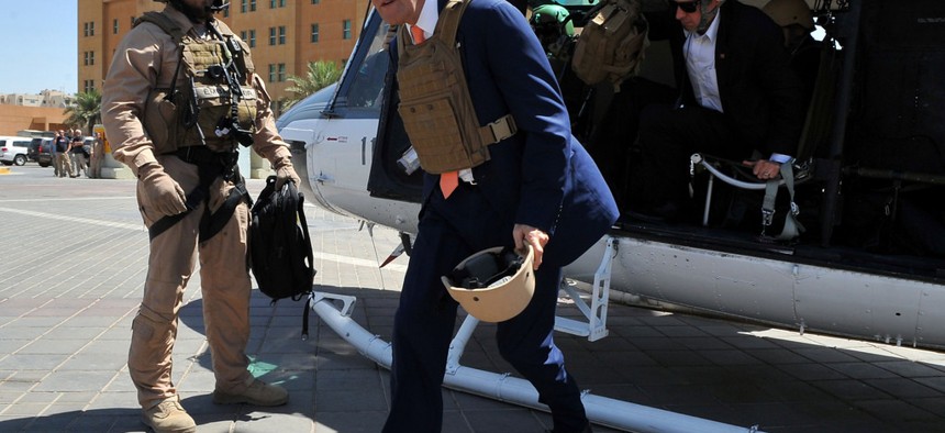 Secretary of State John Kerry steps off a helicopter after arriving at U.S. Embassy Baghdad for meetings with Iraqi government officials, on June 23, 2014. 