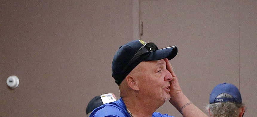 Two Army veterans talk as they wait at a health care crisis center set up by the American Legion in Phoenix, Arizona, on June 10, 2014.