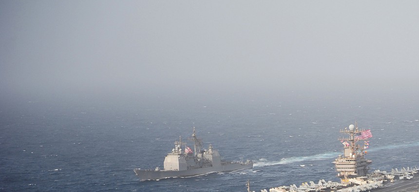 The USS New York (right) sails with the USS Abraham Lincoln and USS Cape St. George through the Arabian Sea, on June 9, 2012.