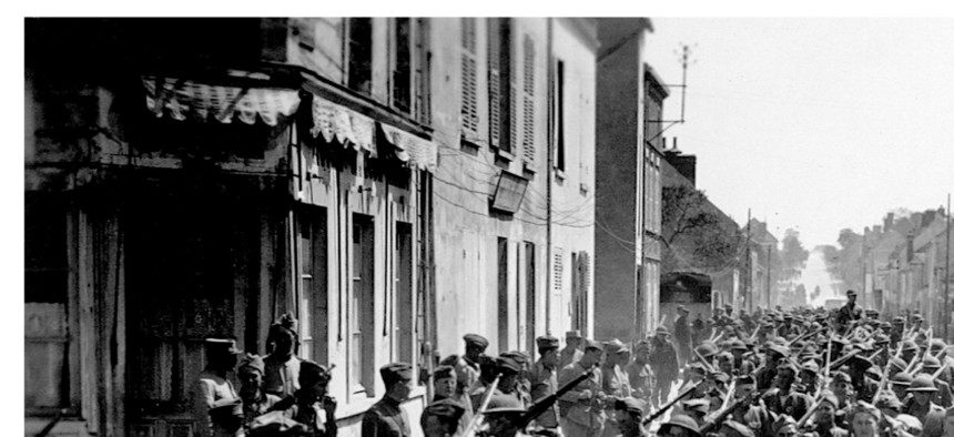 Soldiers with the 30th Infantry, 3rd Division, march through Viele Maisons, France, on June 2, 1918.