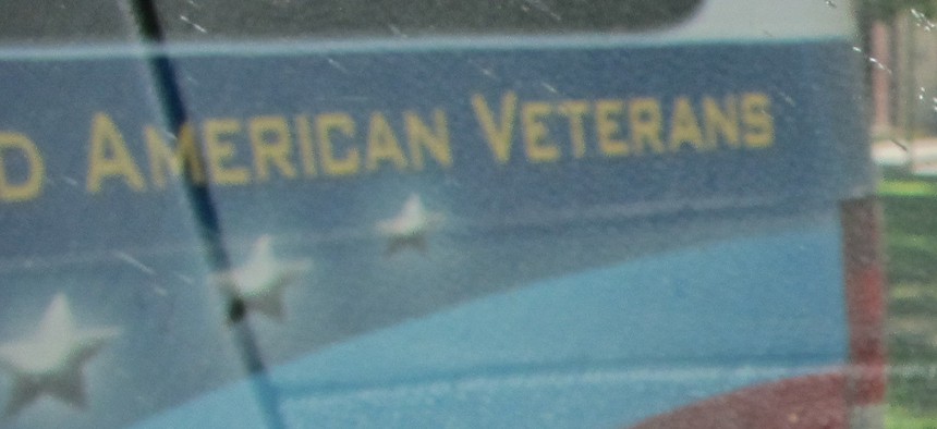 A Vietnam War veteran's cap sits on the dashboard of a vehicle used to transport veterans to medical appointments in New Mexico.  