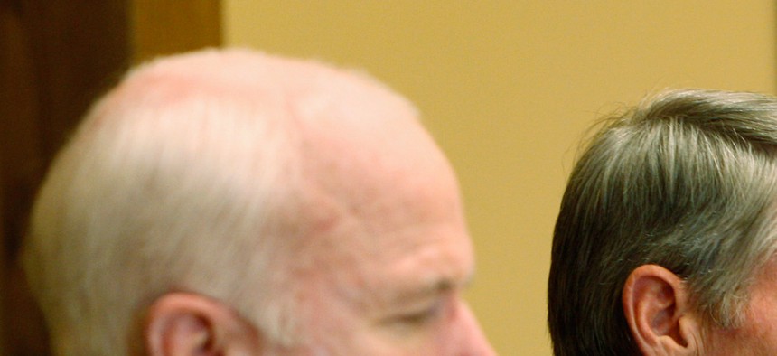 Sen. Mark Udall, D-Colo., right, speaks as Sen. John McCain, R-Ariz., listens at a Senate Field hearing on Aug. 24, 2009.
