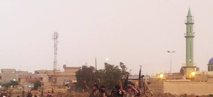 Militants with the Islamic State of Iraq and the Levant parade in the northern city of Mosul, Iraq, on June 25, 2014. 