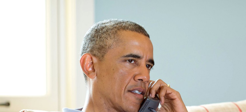 President Obama speaks with Canadian Prime Minister Stephen Harper on the phone in Martha's Vineyard, on August 12, 2014. 
