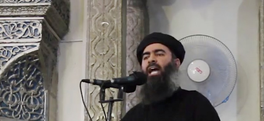 A screengrab from a militant website video Saturday, July 5, 2014, which has been authenticated based on its contents and other AP reporting, purports to show the leader of the Islamic State group, Abu Bakr al-Baghdadi, delivering a sermon at Iraq.