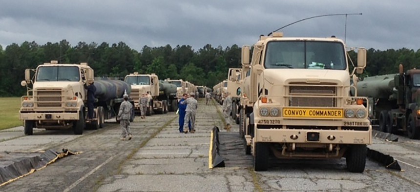 M915A5 line-haul tractor trucks line up at Fort Lee, Va., and prepare for a convoy to Fort A.P. Hill, Va., on June 3, 2013.