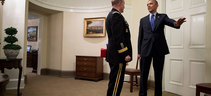 President Obama speaks with Joint Chiefs Chairman Gen. Martin Dempsey after a meeting in the Situation Room on July 19, 2014. 
