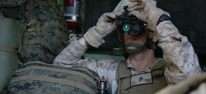 Cpl. Dustin Turner, a rifleman with the 1st Platoon, Company G, adjusts his night vision optics while riding in an Amphibious Assault Vehicle.