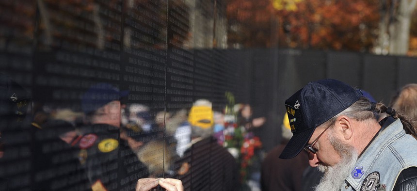 A Vietnam War veteran participates in a ceremony during the 2013 Veterans Day event at the Vietnam War Memorial in Washington, D.C.
