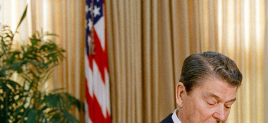 President Ronald Reagan checks his watch while talking to Soviet leader Mikhail Gorbachev in the White House. 