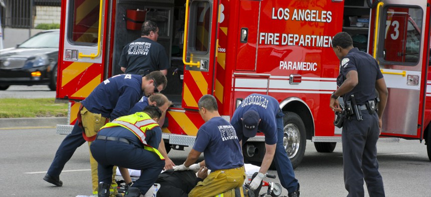 Los Angeles Fire Department workers assist a man in 2011.