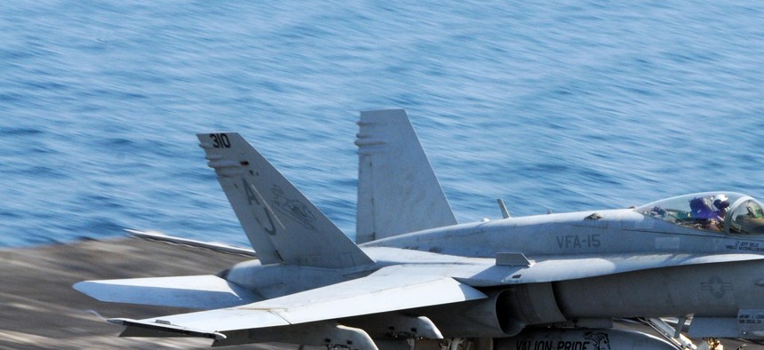 An F/A 18 Hornet prepares to land aboard the USS George H.W. Bush after finishing a mission in the 5th Fleet area of responsibility. 