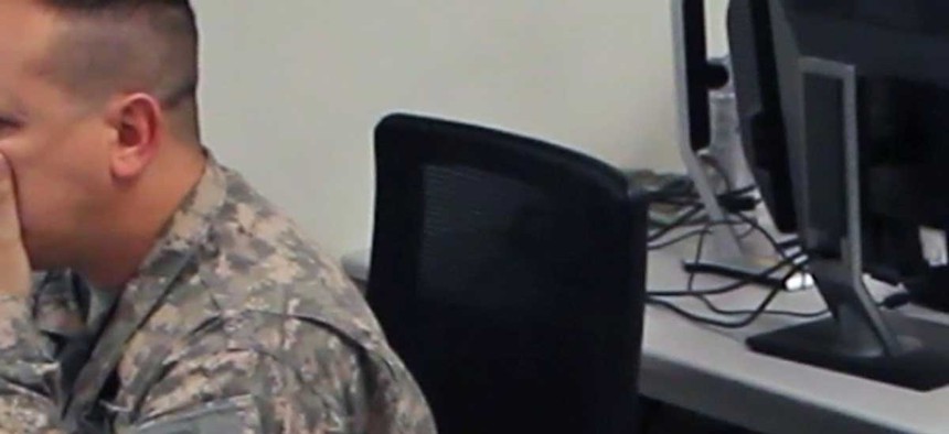 A network analyst with the California Army National Guard works with another analyst to defend against a virus attack during 2014 Cyber Shield exercise. 
