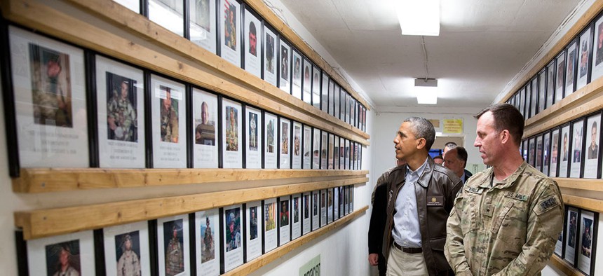 President Barack Obama and Brig. Gen. Erik Kurilla view photos of fallen military personnel at Bagram Airfield, Afghanistan, Sunday, May 25, 2014.