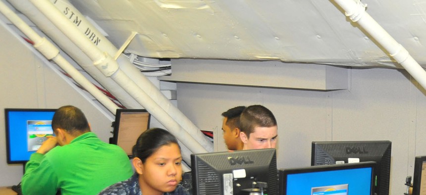 Sailors use computers to check their personal emails aboard the USS Carl Vinson. 