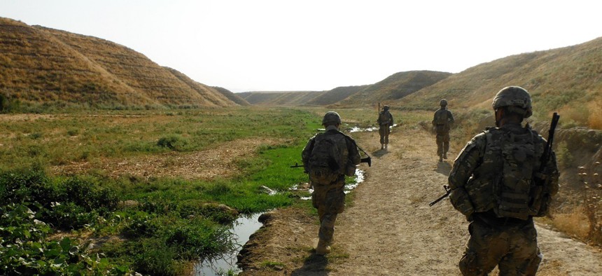 U.S. soldiers assigned to the 3rd Brigade Combat Team, patrol a seasonal river in Kunduz province, Afghanistan, on July 15, 2013. 