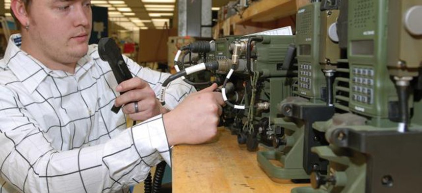 A technician at Tobyhanna Army Depot performs a system check on a series of radio systems. 