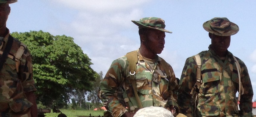 A California National Guard Special Forces soldier reviews a sand table map with a Nigerian soldier in Nigeria.