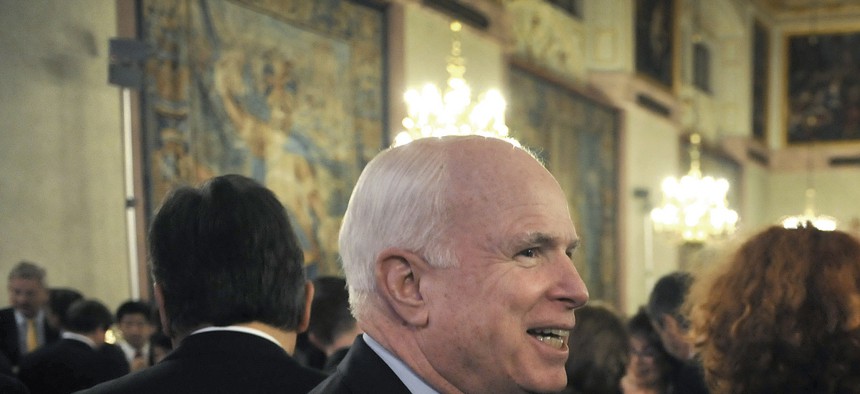 Deputy Secretary of Defense Ashton Carter and Sen. John McCain speak to each other as they await the arrival of Vice President Joe Biden, on February 2, 2013.