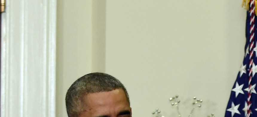 President Obama and Vice President Joe Biden applaud as Ashton Carter, the administration's nominee for defense secretary, speaks at the White House, on December 5, 2014.