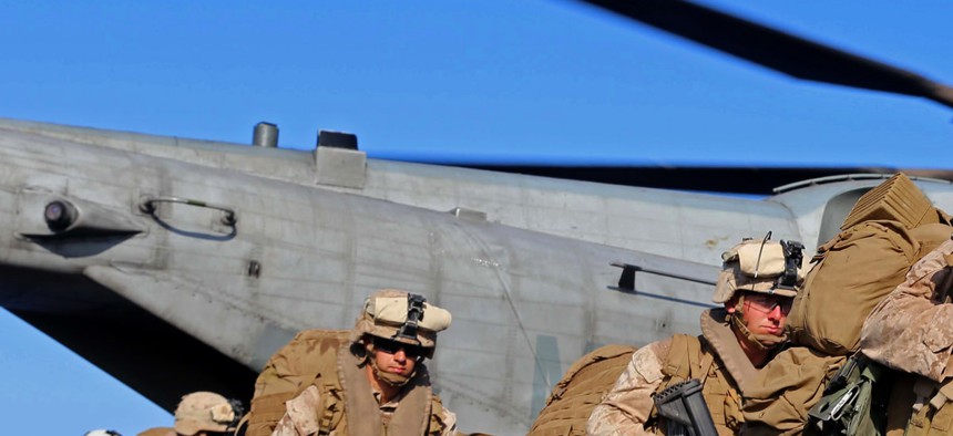 Marines with the 11th MEU offload from a CH-53E Super Stallion on December 12, 2014.