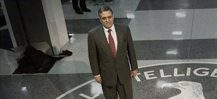 In a March 2001 file photo, then President George W. Bush and then-CIA director George Tenet pose at the CIA seal in the main entrance of agency headquarters in Langley, Va.