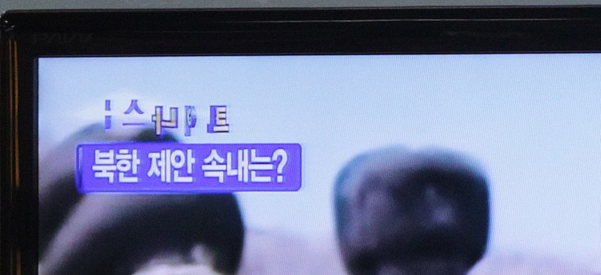 A man watches a TV news program showing North Korean leader Kim Jong-un at the Seoul Railway Station in Seoul, South Korea. 