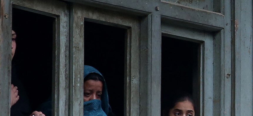 Afghan Shiite women watch a religious ceremony ahead of the Ashouraa holiday, on November 2, 2014.