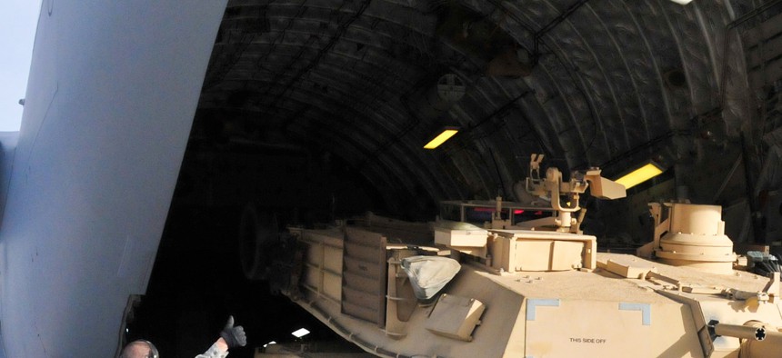 Soldiers from the 4th Infantry Division offload an M1A2 Abrams battle tank from a plane at Fort Carson, on January 13, 2014.