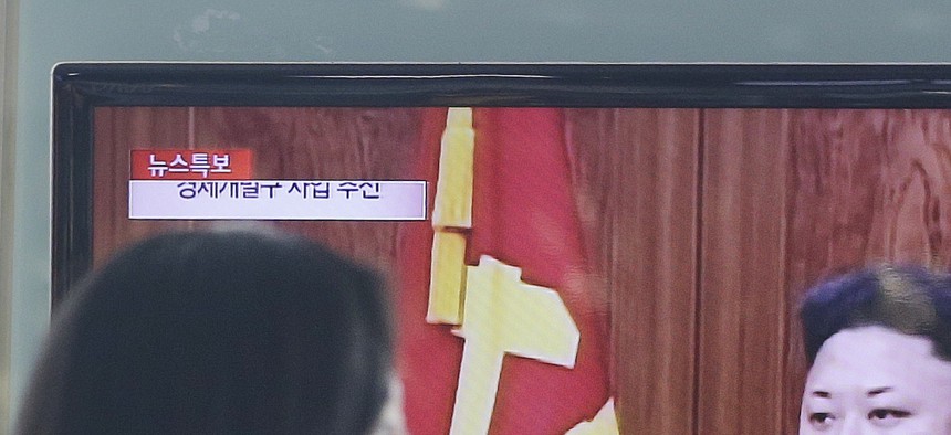 People watch a news program showing North Korean leader Kim Jong-Un delivering a speech, in Seoul, South Korea, on January 1, 2015.