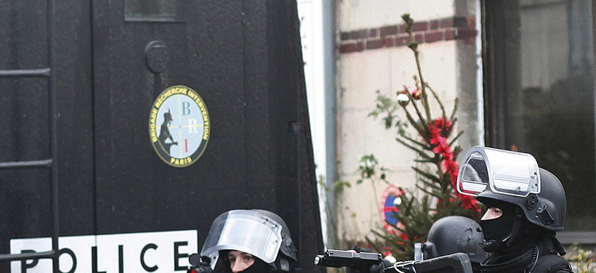 French police officers patrol in Longpont, north of Paris, France, Thursday, Jan. 8, 2015.