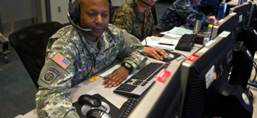 An Army NCO looks through information on a workstation at Combined Air and Space Operations Center-Nellis during Red Flag 14-1.