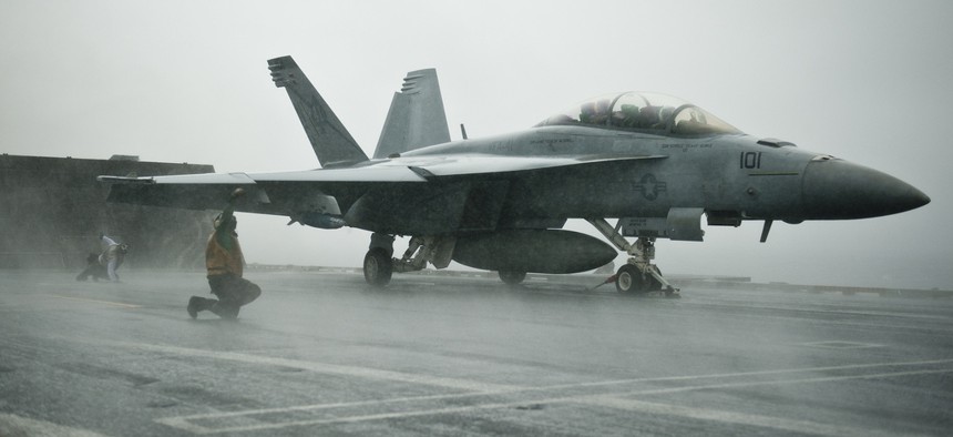 Sailors conduct pre-flight checks on an F/A-18F Super Hornet assigned to Strike Fighter Squadron 41, aboard the USS John C. Stennis, on Sept. 12, 2011.