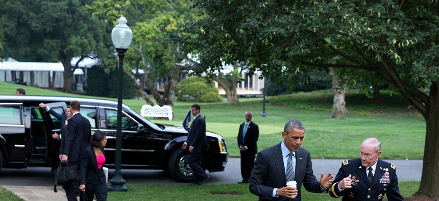 President Barack Obama walks with Gen. Martin Dempsey, Chairman of the Joint Chiefs of Staff, on the South Lawn of the White House, Aug. 6, 2014. 