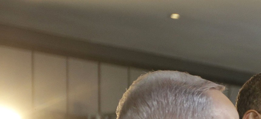 U.S. President Barack Obama, second left, and Israeli Prime Minister Benjamin Netanyahu, left, talk with Professor Amir Geva, right, wearing a device to monitor brain activity. Photo taken in Jerusalem, Israel,Thursday, March 13, 2013. 