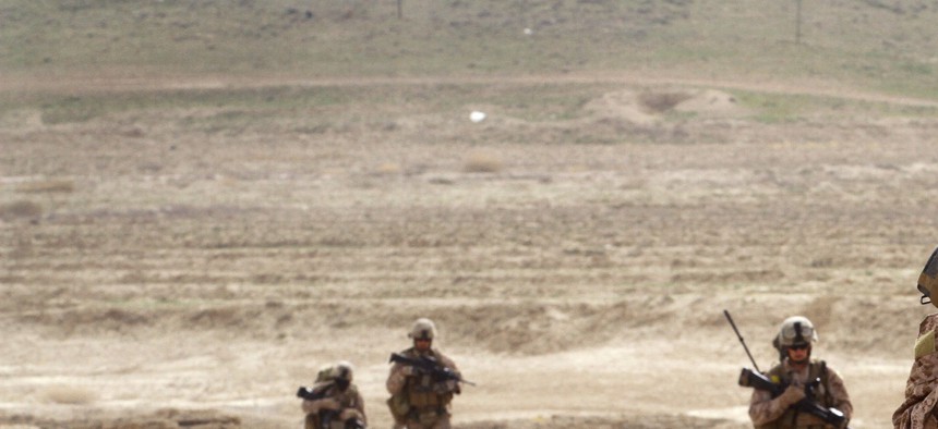 A group of enlisted troops patrol near Observation Post Shrine in the Kajaki District, Afghanistan, on March 16, 2012.