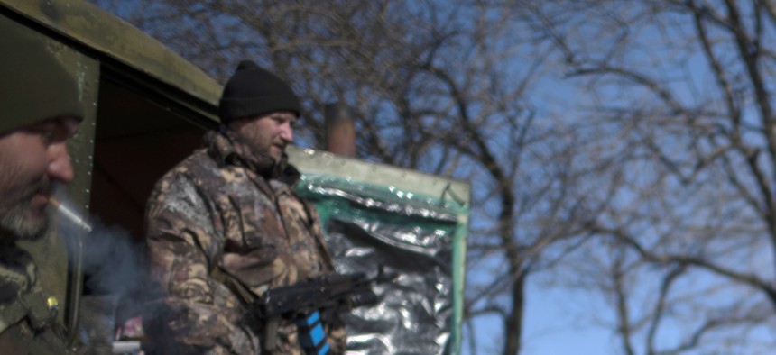Ukrainian military soldiers rest their vehicle near Artemivsk, eastern Ukraine, on Feb. 23, 2015.